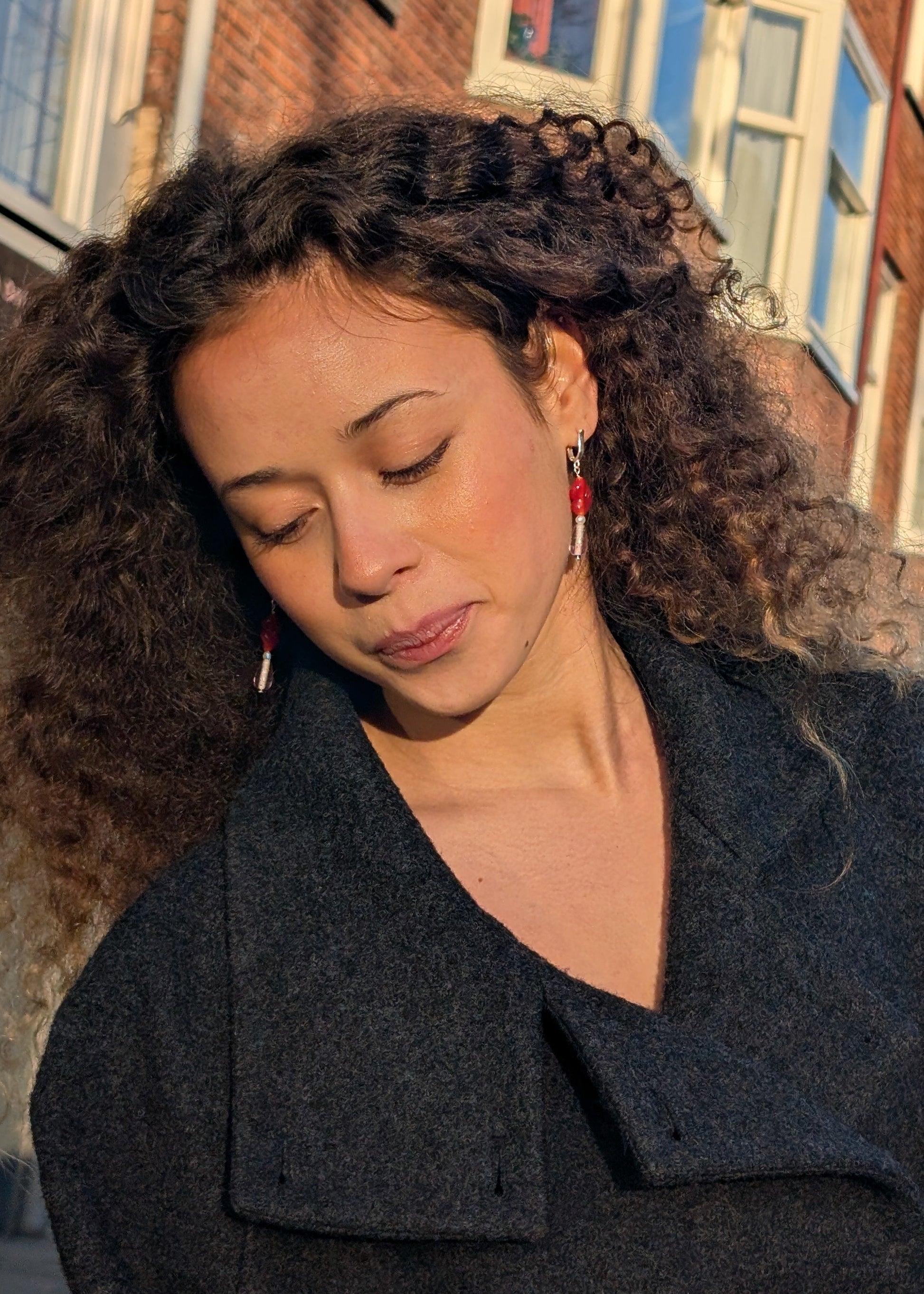Woman wearing a dark coat with a blurred background