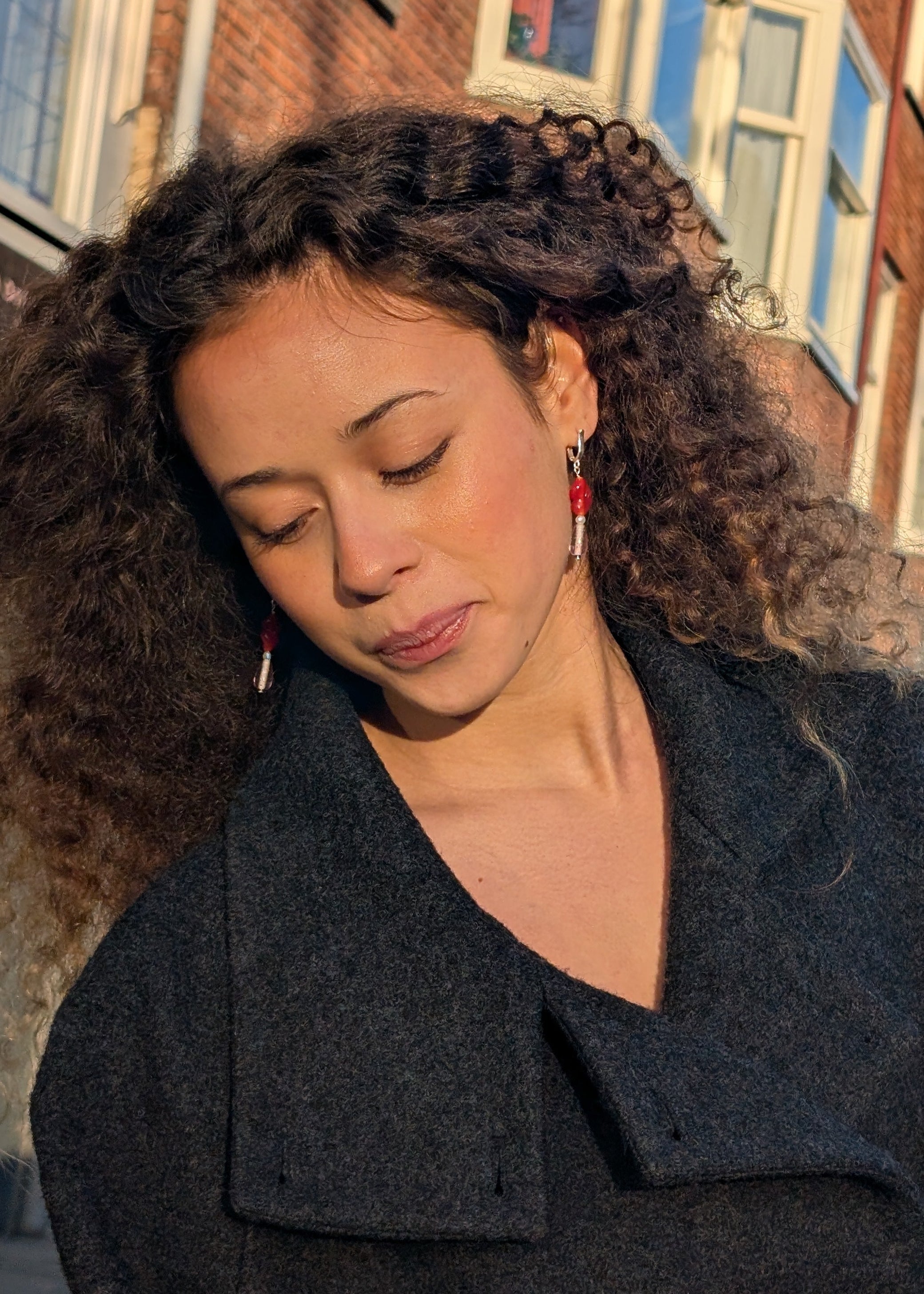 Woman wearing a dark coat with a blurred background