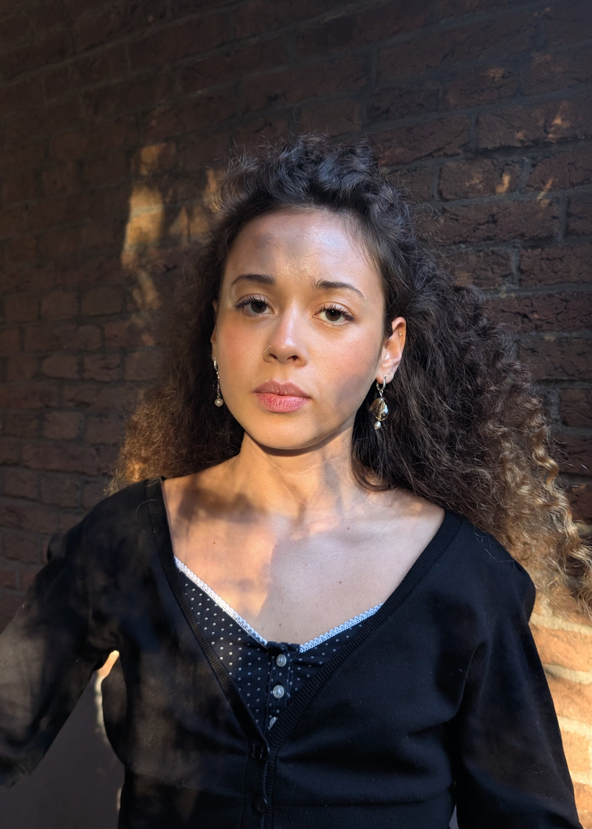Woman wearing a black top with a textured background