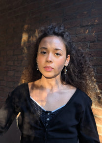 Woman wearing a black top with a textured background