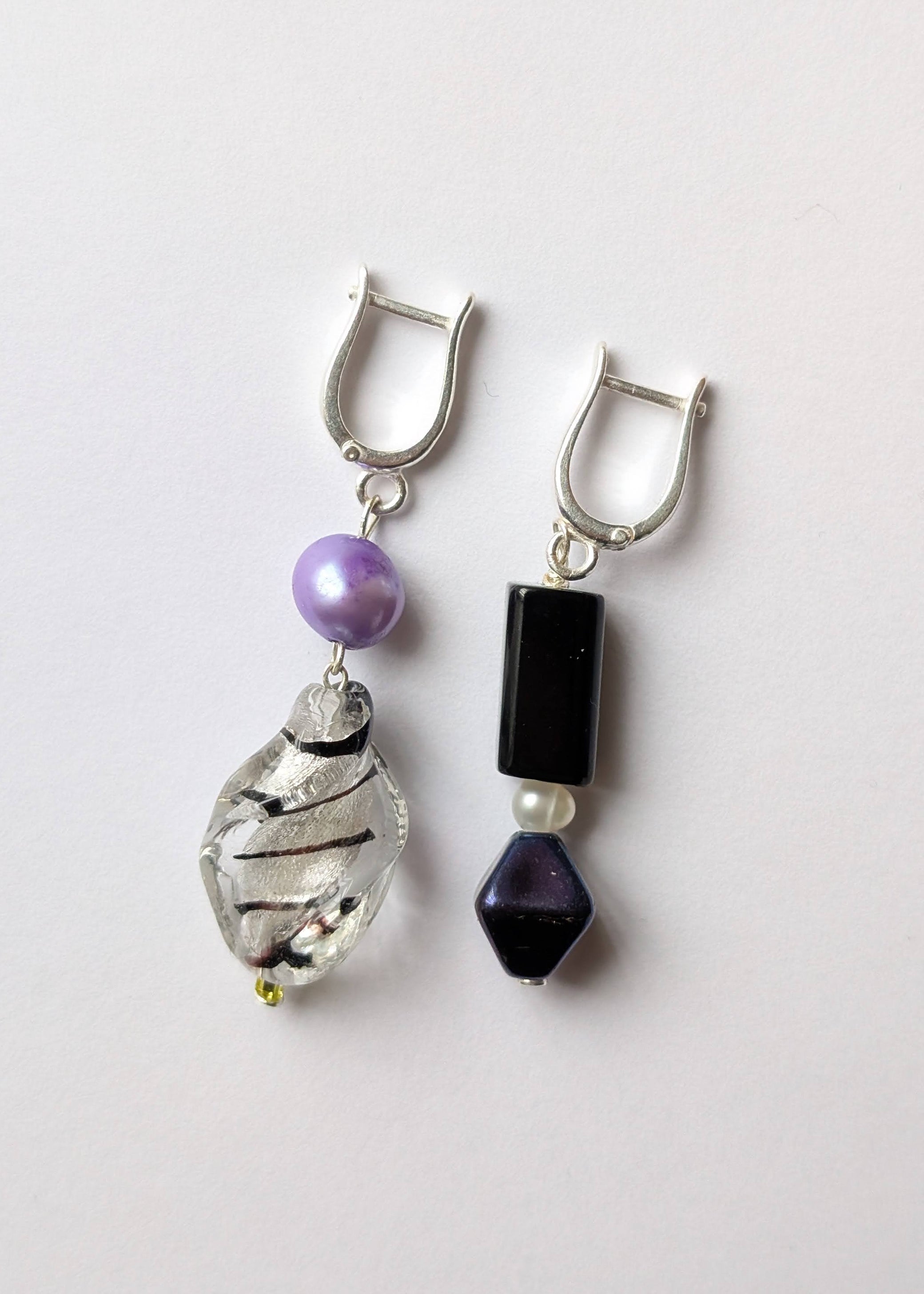Pair of earrings with beads on a light gray background