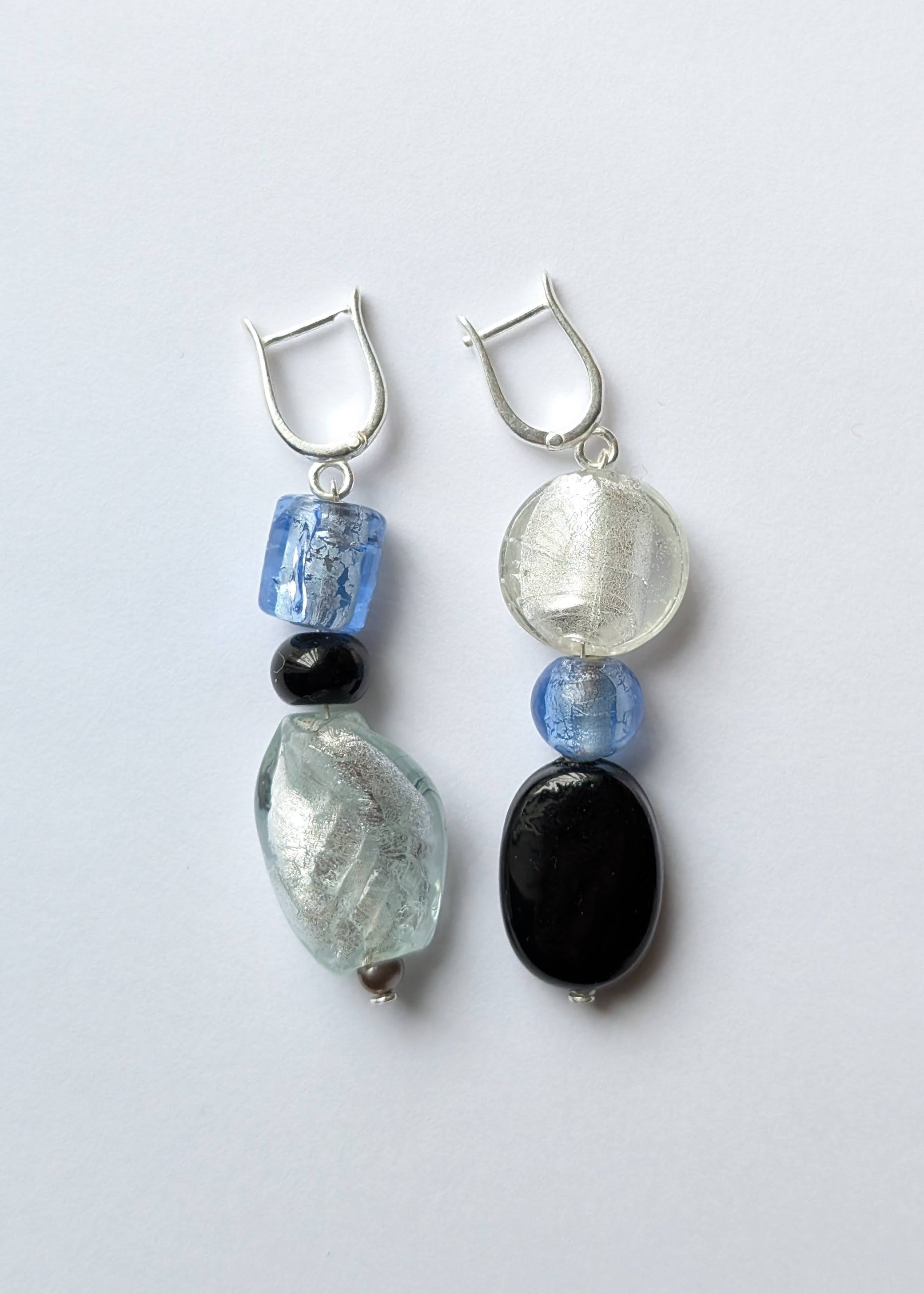 Pair of earrings with beads on a light gray background