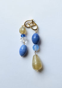 Beaded earring with blue and yellow beads on a white background