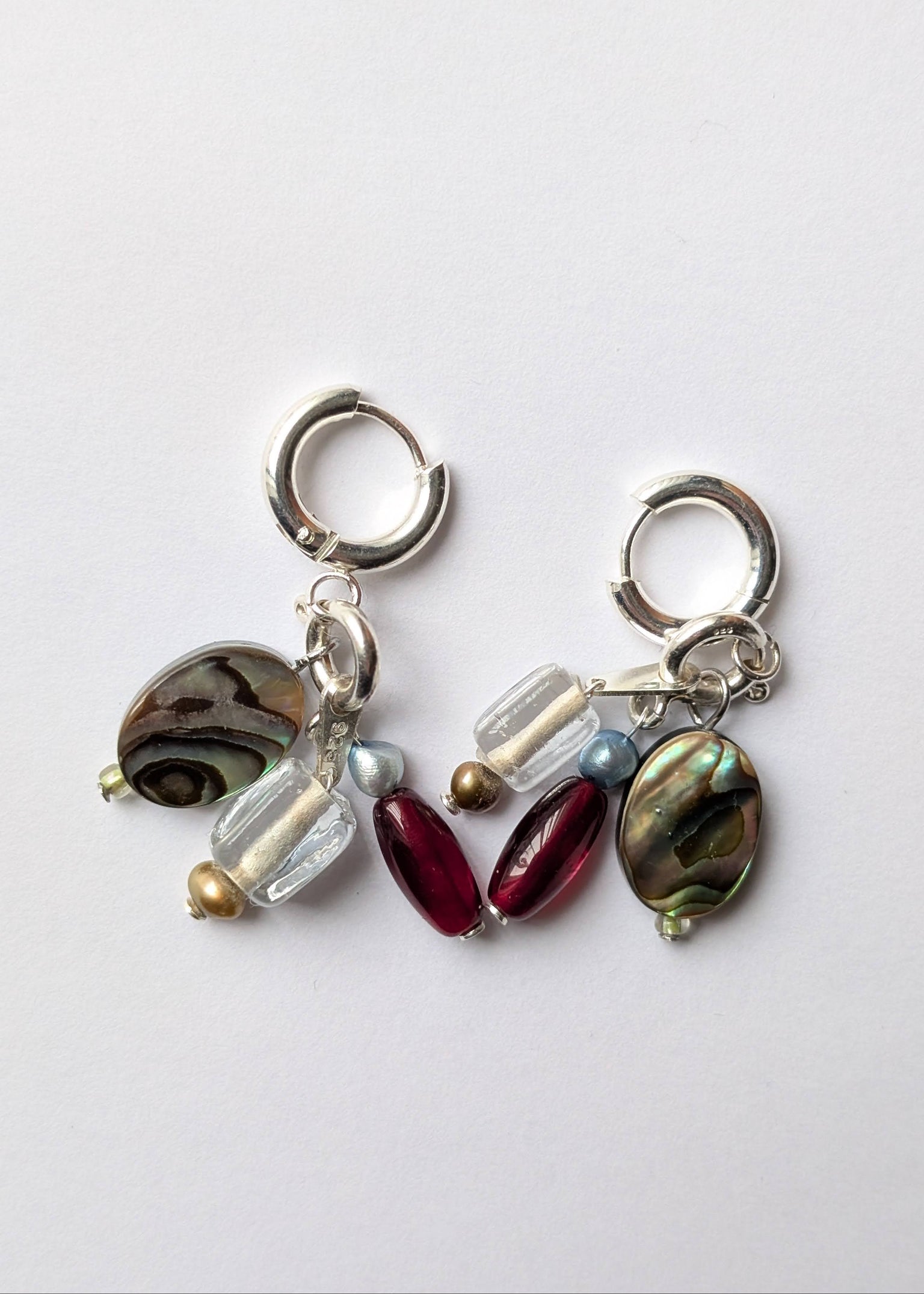 Pair of earrings with various beads on a white background