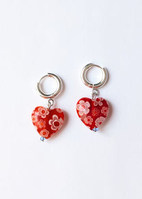 Heart-shaped earrings with floral design on a white background