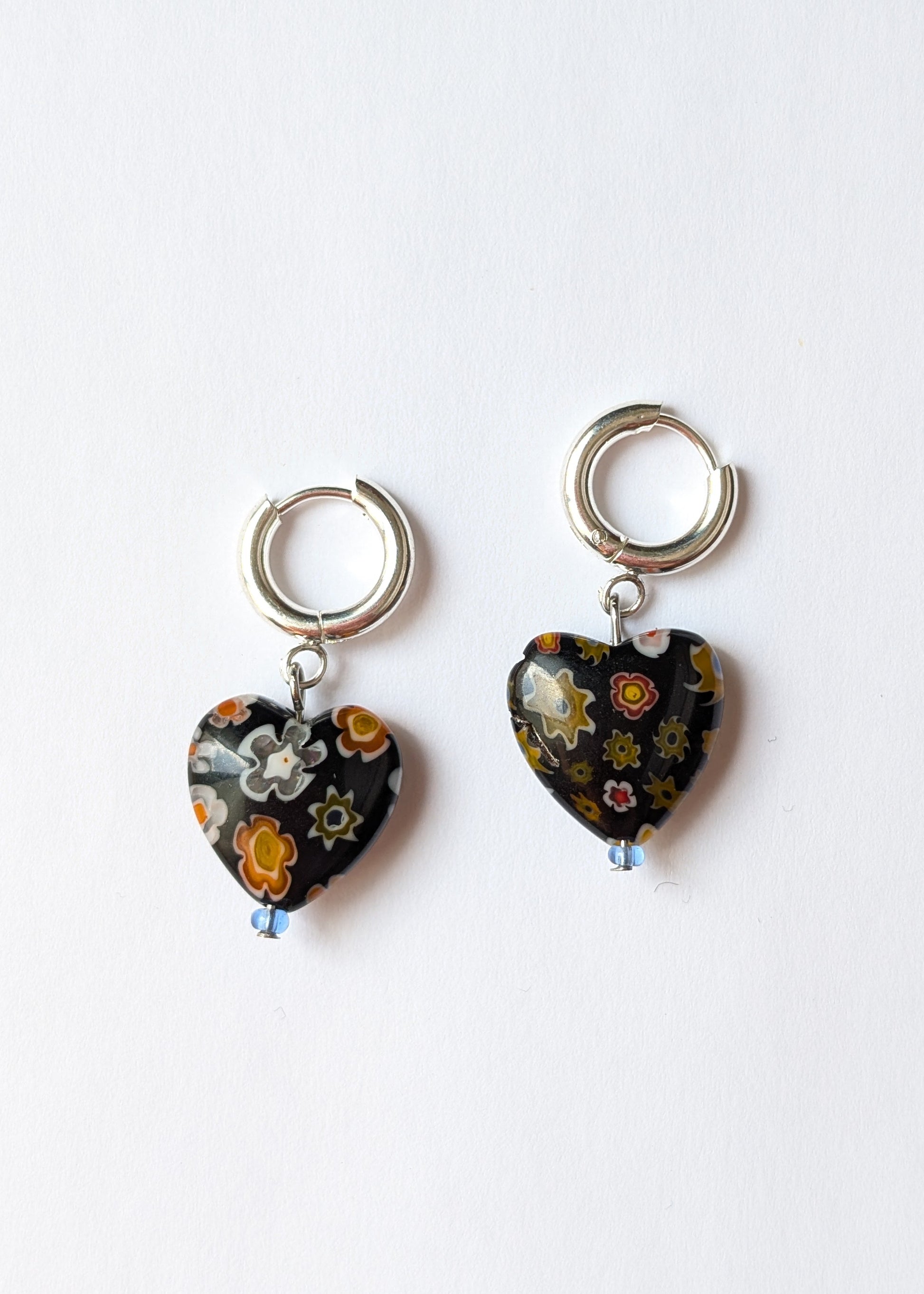 Two floral heart-shaped keychains on a white background
