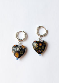 Two floral heart-shaped keychains on a white background