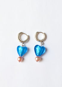 Pair of earrings with blue heart-shaped beads and pink beads on a white background